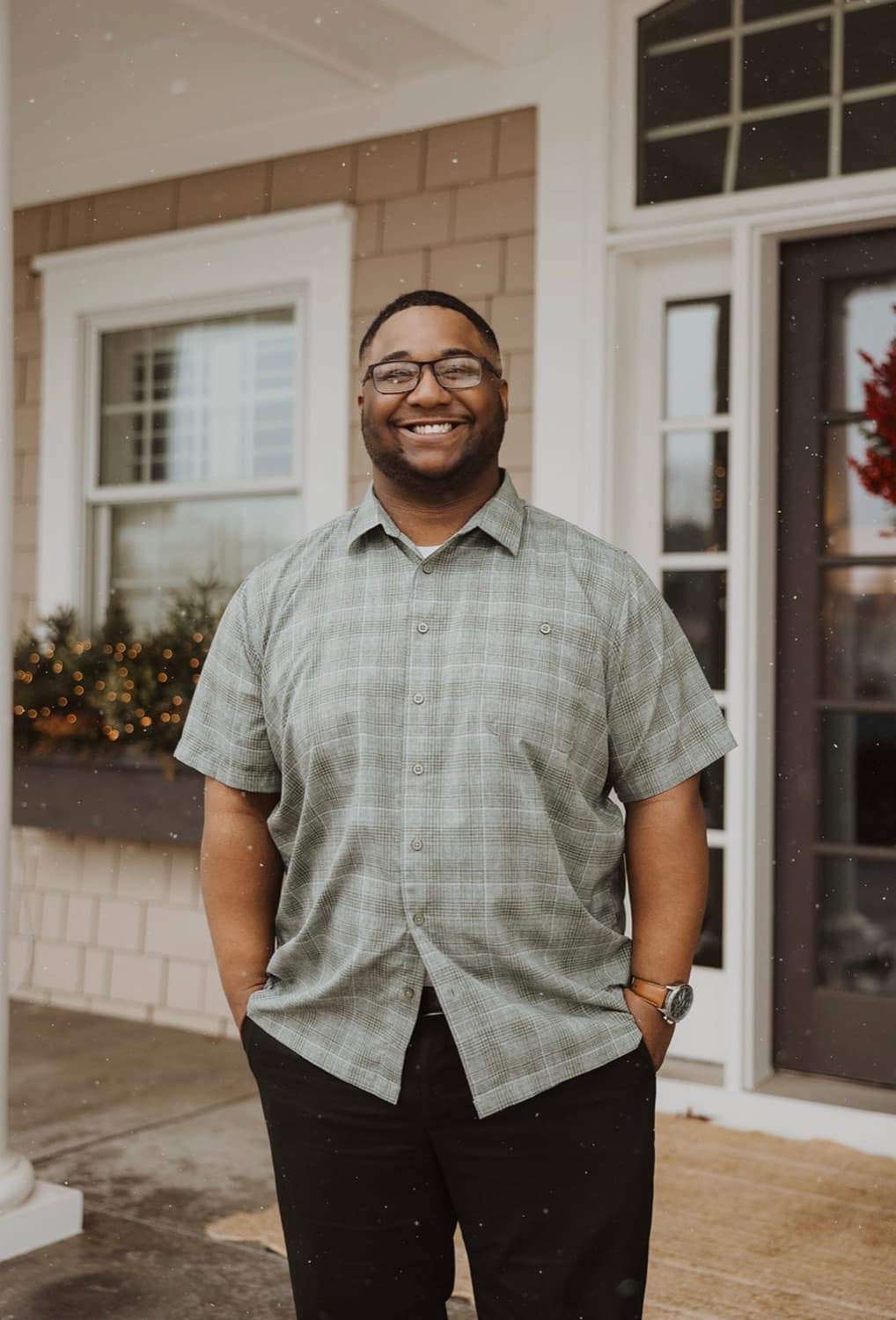 Alonté Alexander, REALTOR® with RE/MAX Results, on the front porch of a Twin Cities home